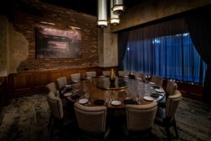 Del fRisco's Double Eagle Steakhouse private dining area lit by a custom overhead fixture.